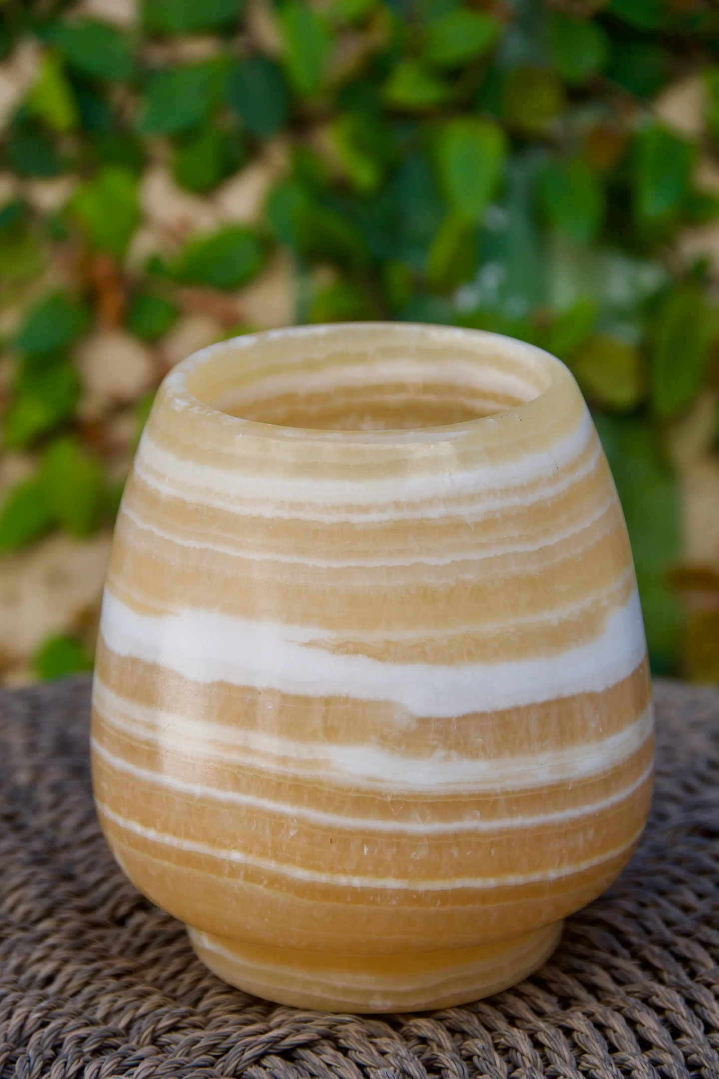 Hand carved alabaster votive revealing fine grain and translucency—detail of artisan craftsmanship.